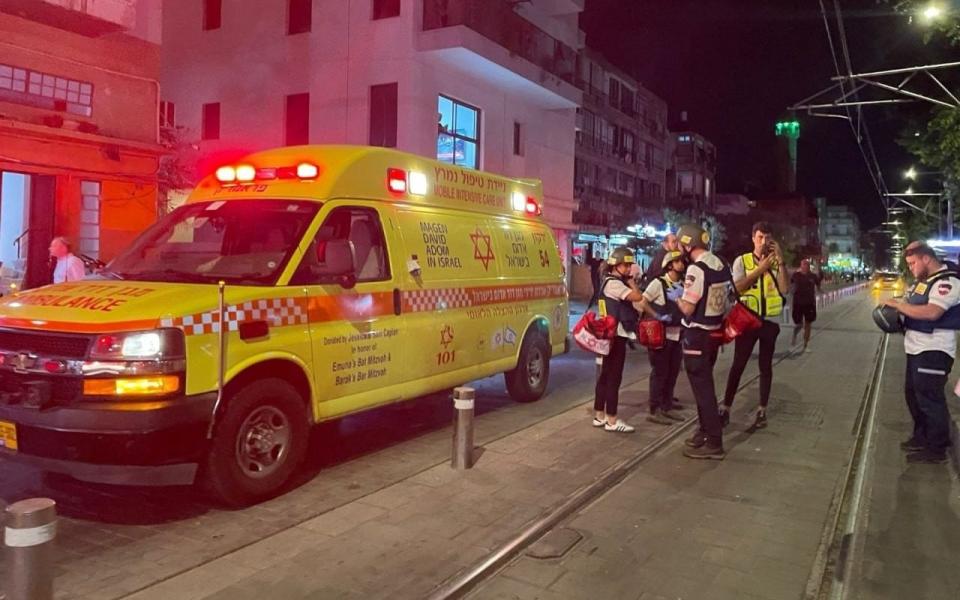 An ambulance is waiting at the scene of the shooting Tuesday evening