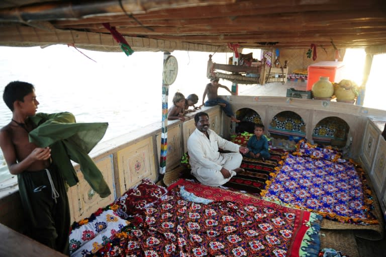 Members of the Mohanna tribe on Pakistan's Manchar Lake, live entirely aboard their boats