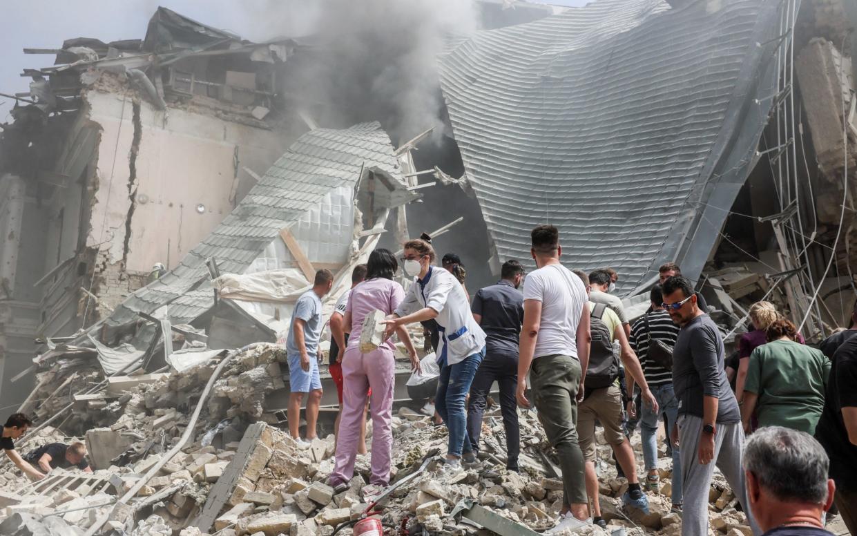 Pictures distributed by officials from the children's medical facility in Kyiv showed people digging through mounds of rubble