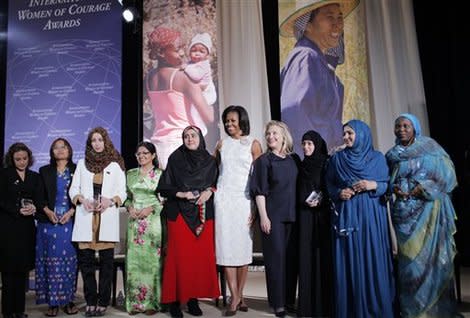 Secretary of State Hillary Rodham Clinton and first lady Michelle Obama with the recipients of the 2012 International Women of Courage Award. (AP Photo/Charles Dharapak)