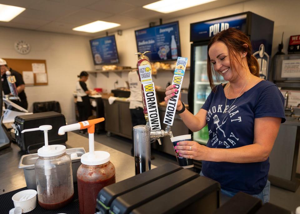 Lauren Ferrara serves up a cold beer at BT's Smokehouse during a WooSox game.