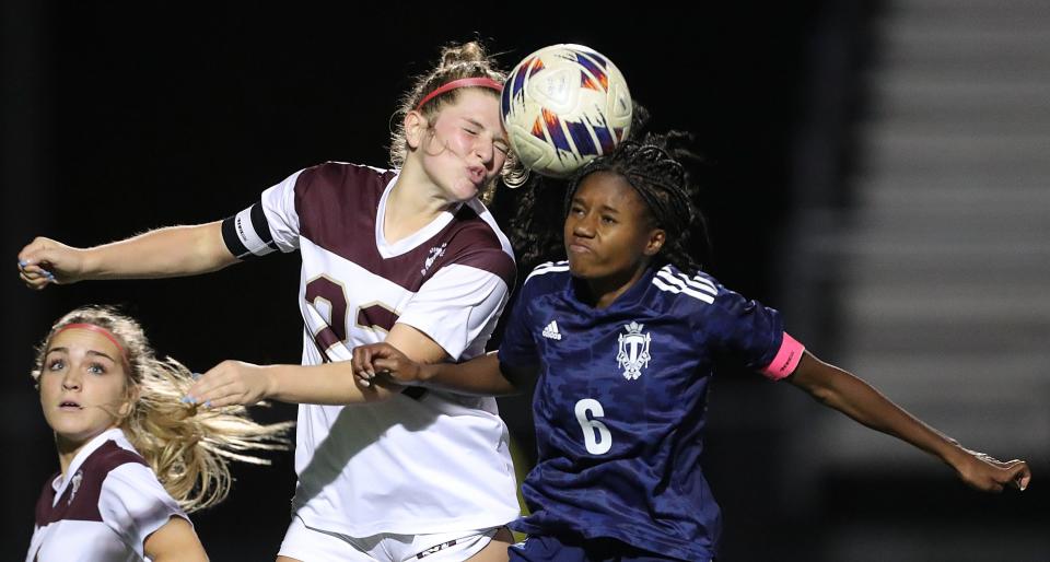 Stow's Addie McCoy, left, and Twinsburg's Jadyn Harrris, right, both attempt to head the ball during the second half of a Division I district semifinal soccer game, Monday, Oct. 24, 2022, in Twinsburg, Ohio.
