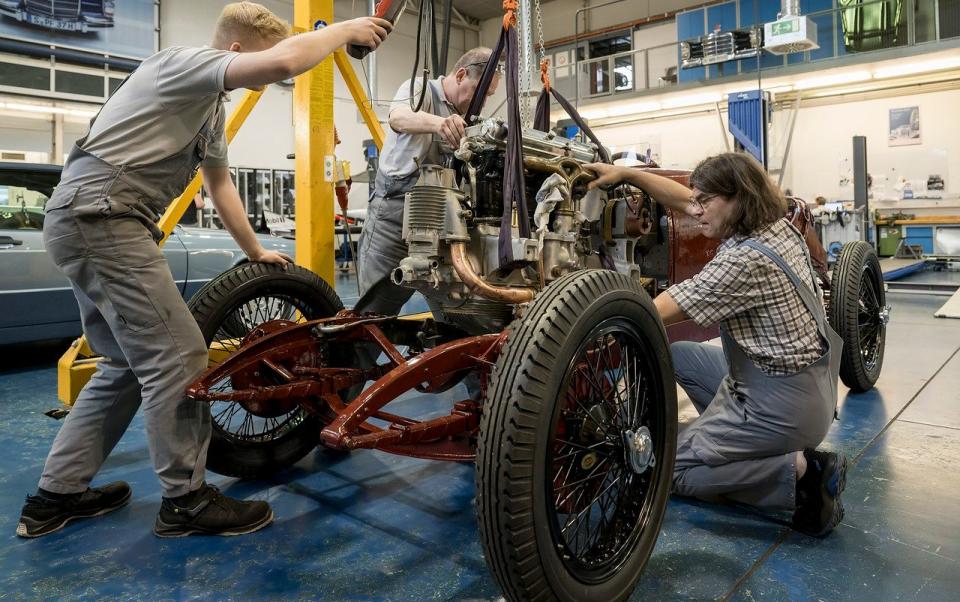 Engineers work on the car