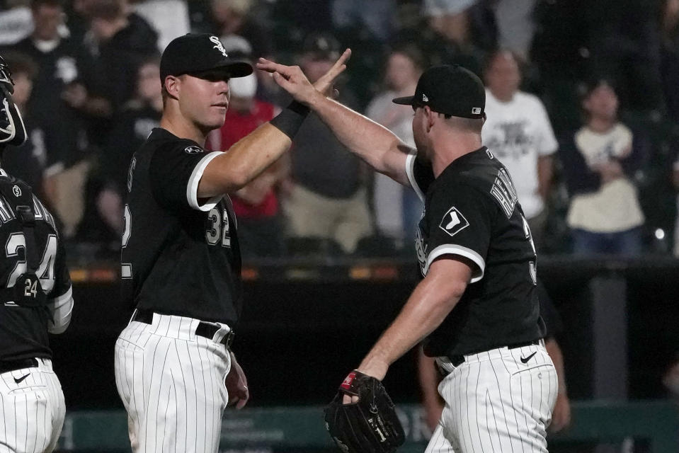 Chicago White Sox's Gavin Sheets, left, and relief pitcher Liam Hendriks celebrate the team's 6-3 win over the Pittsburgh Pirates in a baseball game Wednesday, Sept. 1, 2021, in Chicago. (AP Photo/Charles Rex Arbogast)