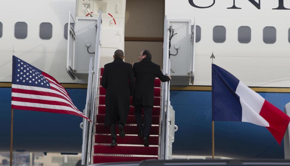 President Barack Obama and French President Francois Hollande walk up the stairs before boarding Air Force One at Andrews Air Force Base, Md., Monday Feb. 10, 2014, for a trip to visit Thomas Jefferson's Monticello in Charlottesville, Va. ( AP Photo/Jose Luis Magana)