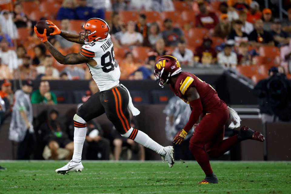 Browns wide receiver Cedric Tillman catches a pass while being covered by Washington Commanders safety Jeremy Reaves during a preseason game, Friday, Aug. 11, 2023, in Cleveland.