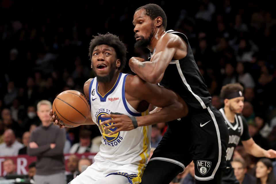 James Wiseman, left, makes a move on Kevin Durant in a Dec. 21 game between the Warriors and Nets. Both players were involved in trades leading up to the NBA's trade deadline Thursday afternoon.