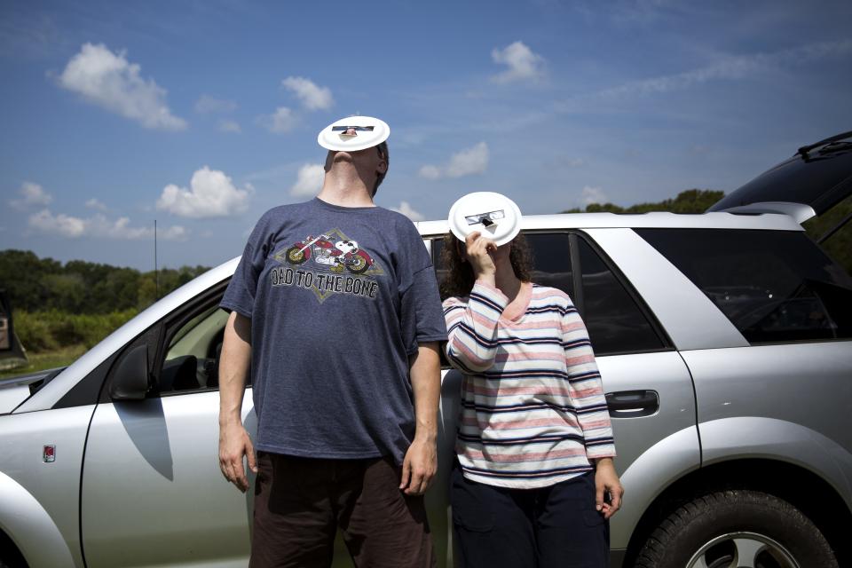 Tammy and Paul Bronk use adapted eclipse glasses, to screen their faces from the sun, while viewing the early stages of the total solar eclipse from Giant City State Park near Carbondale Monday, Aug. 21, 2017. "It went fast but yet it felt like time stood still. Twilight and still and perfect, it was so beautiful," Tammy Bronk said. [Rich Saal/The State Journal-Register]