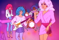 <p>No, we’re not talking about the 2015 live-action film. The original cartoon series is about Jem, the lead singer, and her musical group, “the Holograms,” who are also her adopted sisters. Jem is a predecessor of Hannah Montana — her real name is Jerrica Benton, but her identity is hidden due to holographic technology that disguises her as the rock star. As a devoted sisterhood, the band protects her identity. <i>(Source: Hasbro)</i></p>