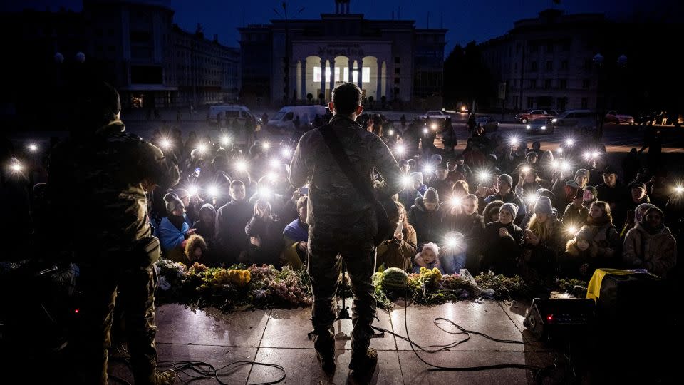 Ukrainian musician Kolya Serga plays to a crowd in Kherson's central Freedom Square on November 18. - Ed Ram/Reuters