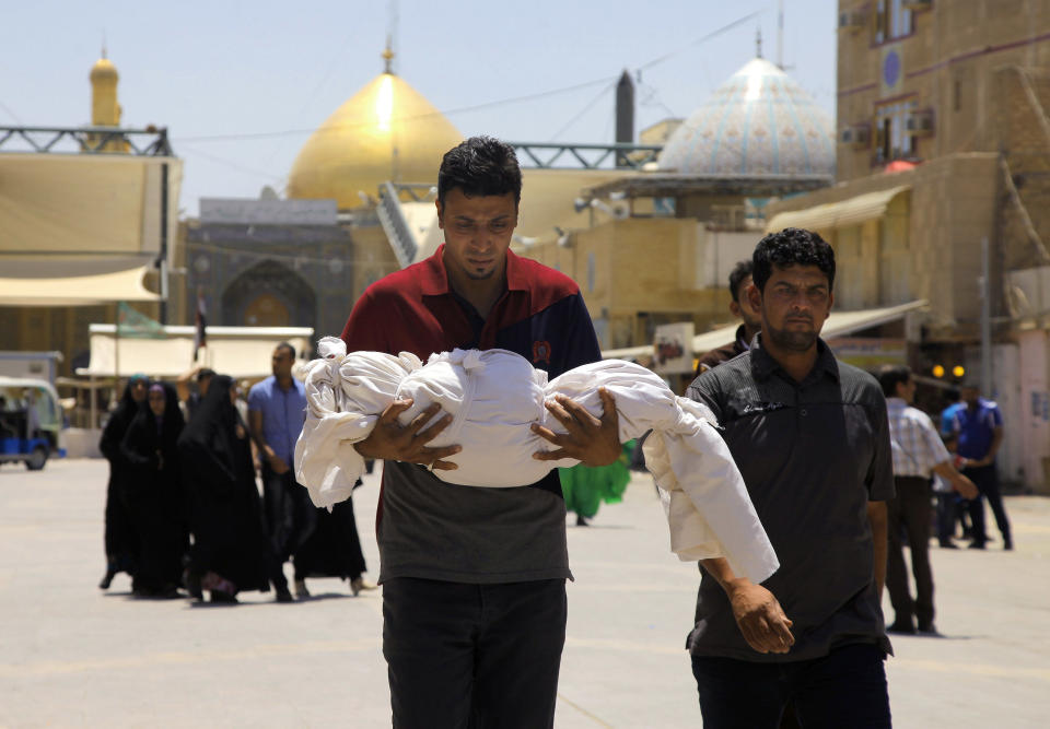Mohammed Mahmoud carries the lifeless body of his 18-month old nephew Mustafa, who was killed in a bombing on Tuesday, before his burial in the Shiite holy city of Najaf, 100 miles (160 kilometers) south of Baghdad, Iraq, Wednesday, May 14, 2014. Militants unleashed a wave of car bombings in Baghdad on Tuesday, killing dozens and sending thick, black smoke into the air in a show of force meant to intimidate Iraq’s majority Shiites as they marked what is meant to be a joyous holiday for their sect. (AP Photo/Jaber al-Helo)