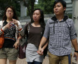 Relatives of victims who were killed in a ferry collision, leave a public mortuary in Hong Kong Tuesday, Oct. 2, 2012. A boat packed with revelers on a long holiday weekend collided with a ferry and sank off Hong Kong, killing at least 36 people and injuring dozens, authorities said. (AP Photo/Kin Cheung)