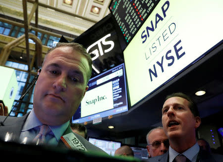 Specialist Trader Glen Carell (R) gives a price for Snap Inc. during the company's IPO on the floor of the New York Stock Exchange (NYSE) in New York, U.S. on March 2, 2017. REUTERS/Brendan McDermid/File Photo