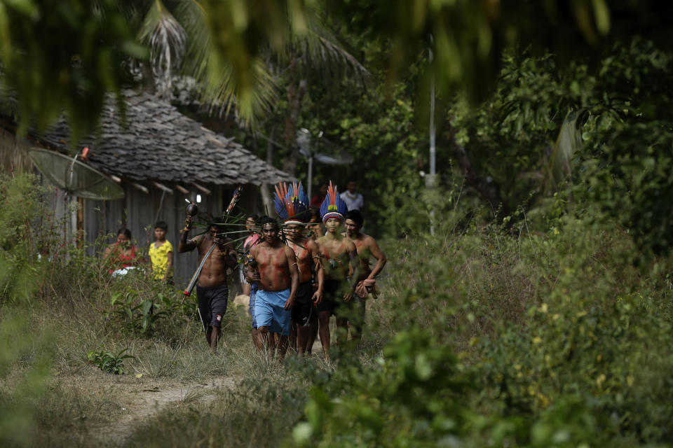 Members of the Tenetehara Indigenous arrive to take part in a festival in the Alto Rio Guama Indigenous Reserve, where they have enforced six months of isolation during the COVID-19 pandemic, near the city of Paragominas, Para state, Brazil, Monday, Sept. 7, 2020. The Indigenous group, also known as Tembe, are celebrating and giving thanks that none of their members have fallen ill with COVID-19, after closing their territory from outsiders since March. (AP Photo/Eraldo Peres)