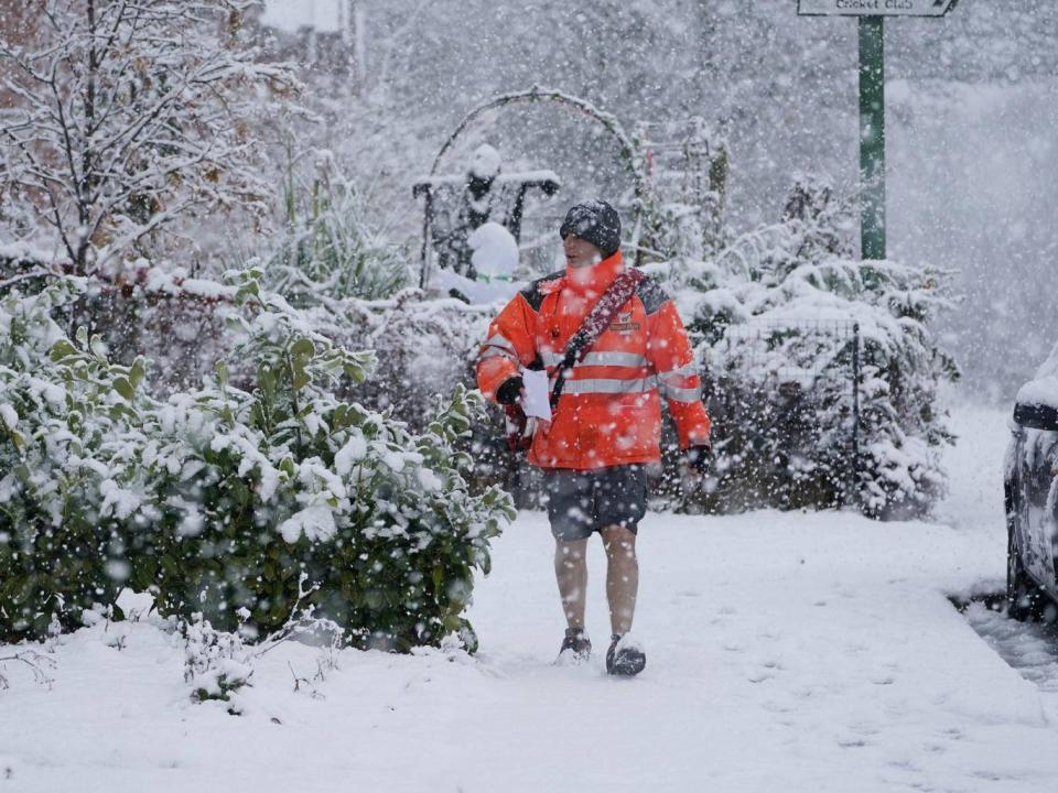 A postman in shorts delivers mail in the snow near Consett, County Durham, Saturday, 27 October, 2018. (Owen Humphreys/PA)