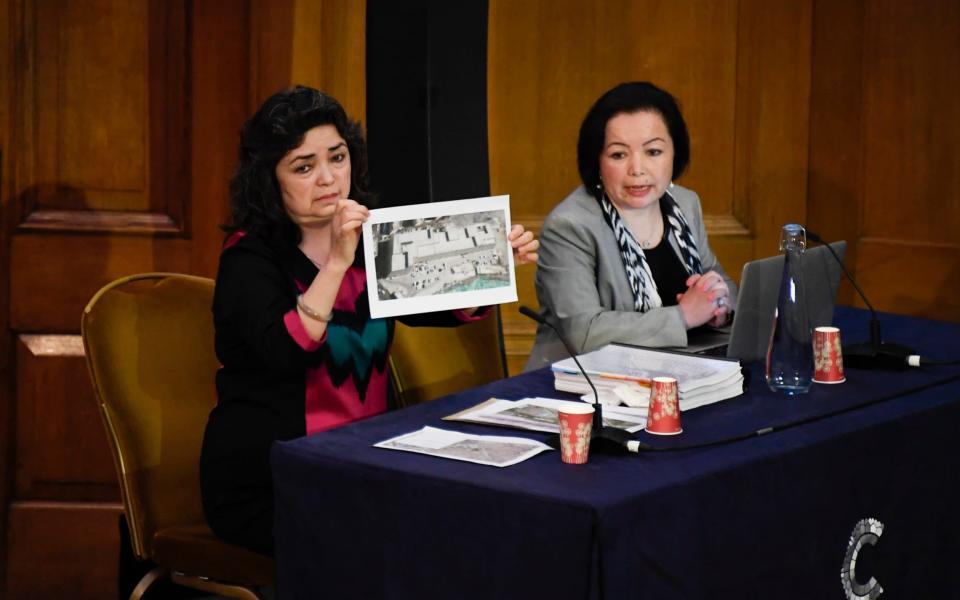 Witness Qelbinur Sidik shows a picture purported to be of a detention camp, to the Panel of the independent Uyghur Tribunal during the first session of the hearings in London, Friday, June 4, 2021. In June 2020 Dolkun Isa, President of the World Uyghur Congress formally requested that Geoffrey Nice QC establish and chair an independent people's tribunal to investigate alleged atrocities and possible Genocide against the Uyghur people.  - Alberto Pezzali/AP