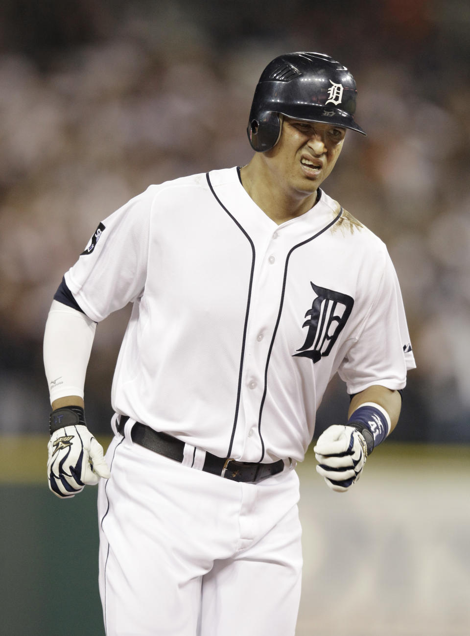 Detroit Tigers' Victor Martinez grimaces as he rounds third base after hitting a solo home run to right right in the fourth inning of Game 3 of baseball's American League championship series against the Texas Rangers, Tuesday, Oct. 11, 2011, in Detroit. (AP Photo/Paul Sancya)