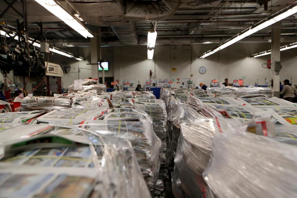 Thanksgiving newspapers are stacked in the press area in 2018.