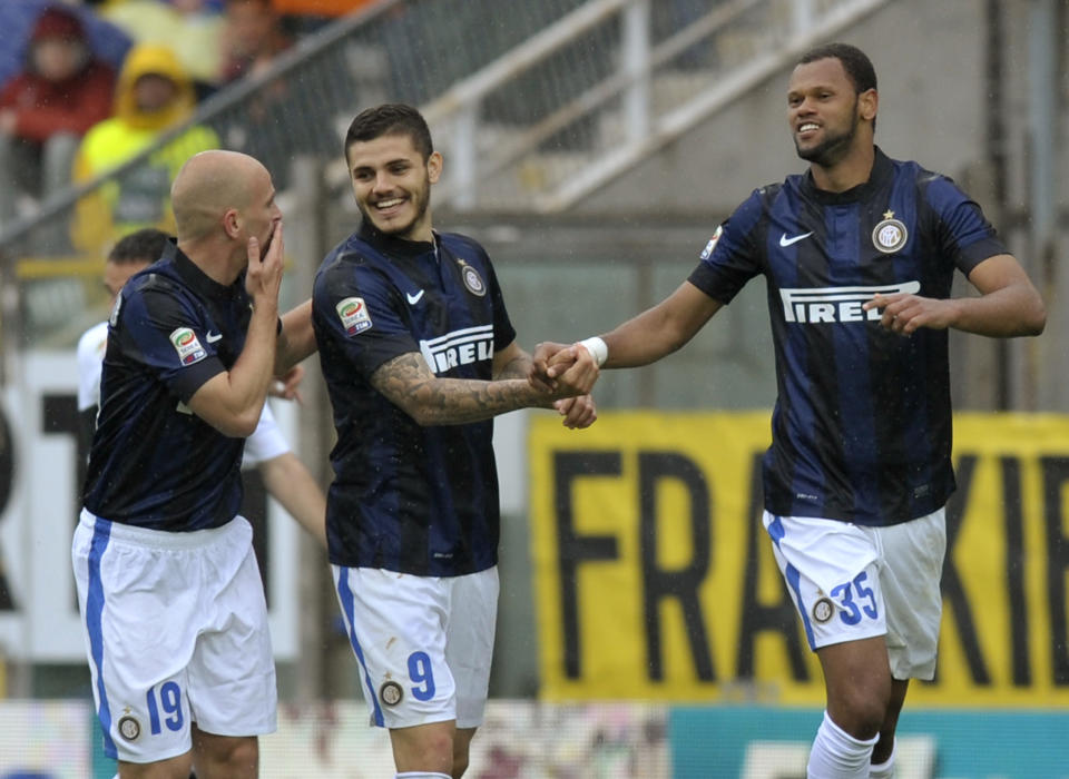 Inter Milan's Jorge Fonseca Rolando of Portugal, right, celebrates with his teammates Mauro Icardi, center, and Estebasn Cambiasso, after scoring against Parma during their Italian Serie A soccer match at Tardini stadium in Parma, Italy, Saturday, April 19, 2014. (AP Photo/Marco Vasini)