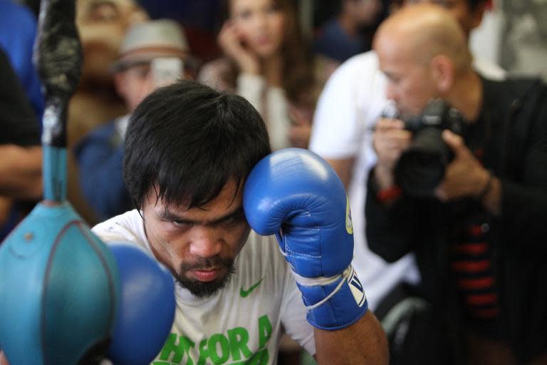 Manny Pacquiao hits the double end bag during his media workout day at the Wild Card Boxing Gym on April 2, 2014 in Hollywood, California