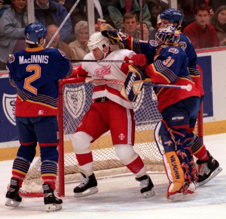 Detroit Red Wings' Vladimir Konstantinov gets ganged up on by St. Louis Blues' Al MacInnis, Grant Fuhr and Igor Kravchuk during the first period in Game 2 of the playoffs at Joe Louis Arena, April 18, 1997.