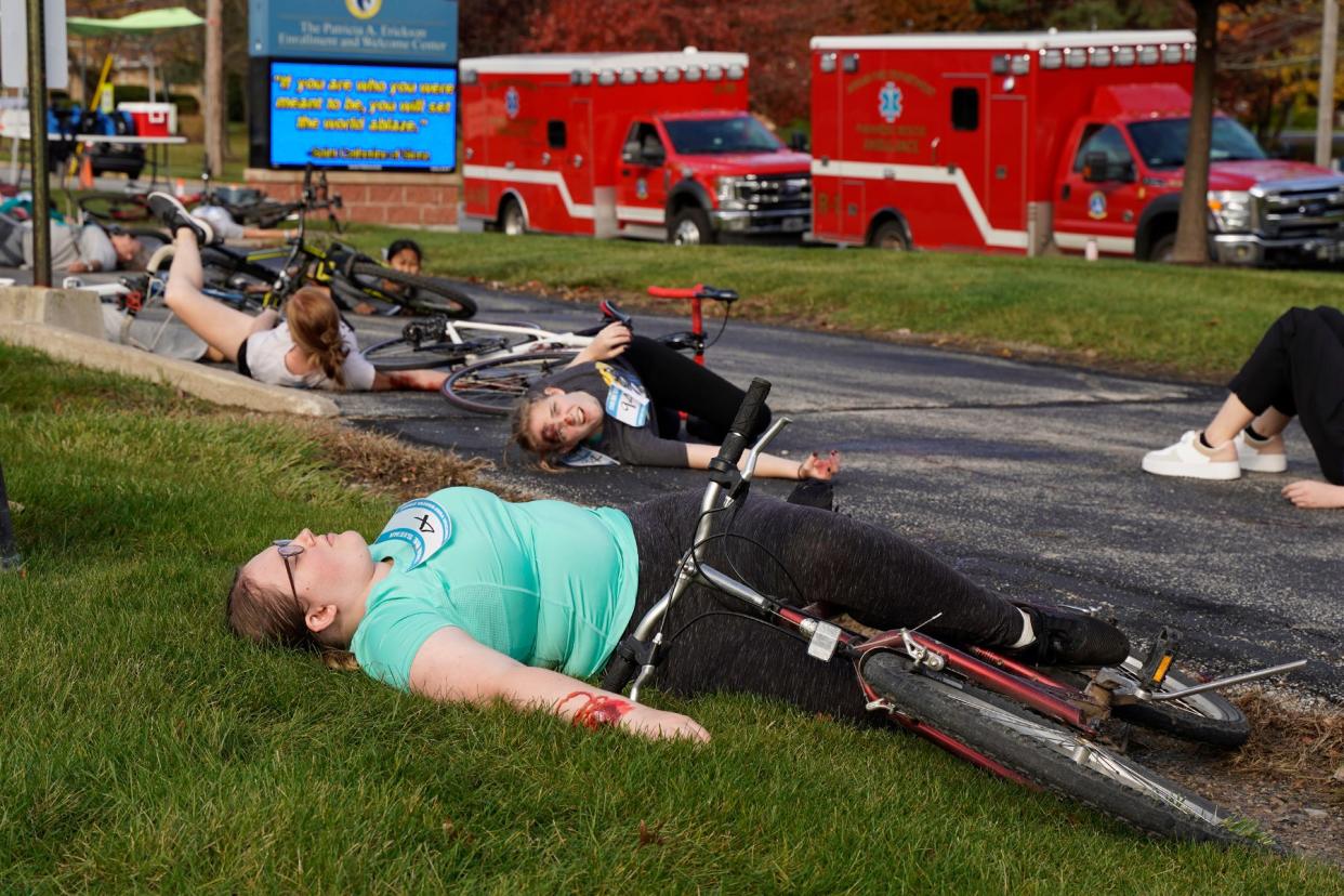 Adrianna Nelson, a senior at Siena Heights University, awaits medical attention Oct. 27 during a mock disaster on SHU's Adrian campus titled “Tour de Sienna," a 25-bike pileup that required the attention of junior nursing students from the university.