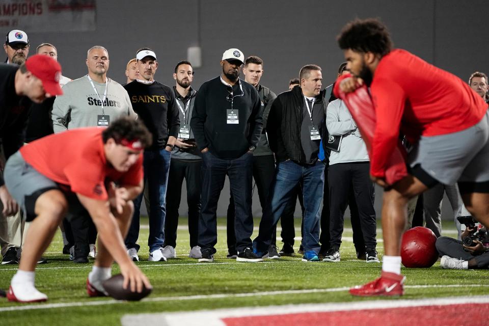 NFL representatives watch as Ohio State Buckeyes Luke Wypler  and offensive tackle Paris Johnson work out during Ohio State football’s pro day at the Woody Hayes Athletic Center in Columbus on March 22, 2023. 