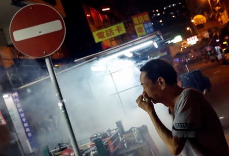 A man reacts after the police fired tear gas to disperse anti-extradition bill protesters demonstration at Sham Shui Po, in Hong Kong