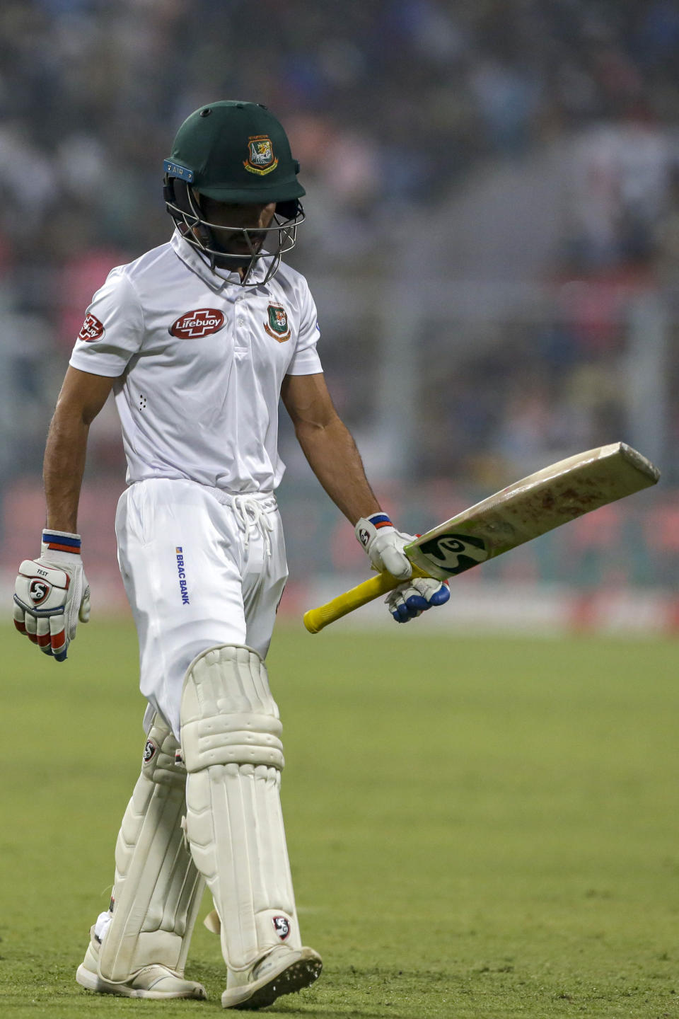 Bangladesh's captain Mominul Haque walks back to the pavilion after being dismissed during the second day of the second test cricket match between India and Bangladesh, in Kolkata, India, Saturday, Nov. 23, 2019. (AP Photo/Bikas Das)