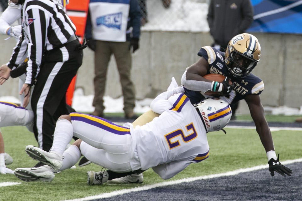 Montana State's Isaiah Ifanse plows over Albany's Tyler Carswell on his way to a first-half touchdown during a second-round game in the NCAA Football Championship Subdivision playoffs Saturday, Dec. 7, 2019, in Bozeman, Mont. (Ryan Berry/Bozeman Daily Chronicle via AP)