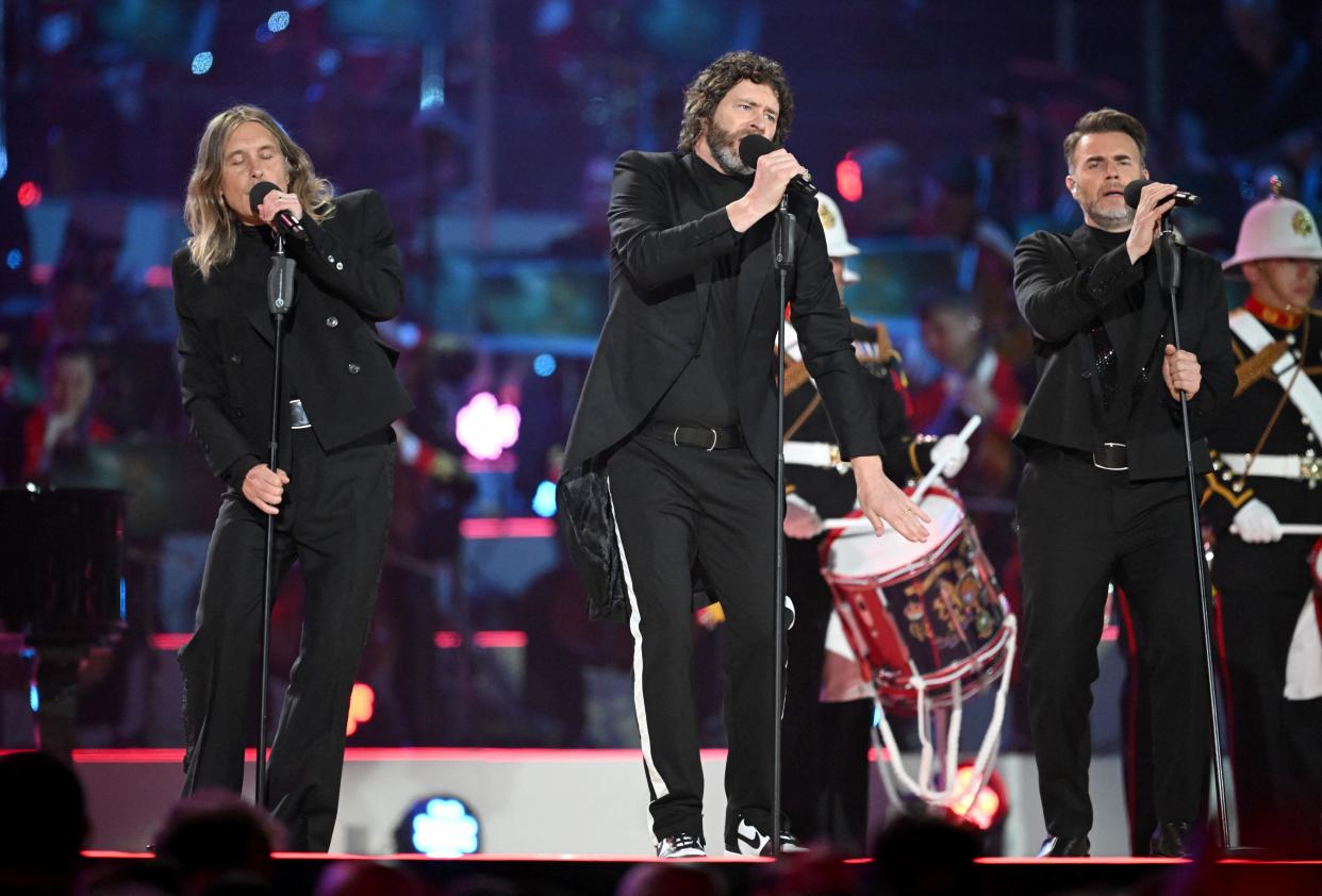 Take That (L-R) Mark Owen, Howard Donald and Gary Barlow perform inside Windsor Castle King Charles grounds at the Coronation Concert, in Windsor, west of London on May 7, 2023. - For the first time ever, the East Terrace of Windsor Castle will host a spectacular live concert that will also be seen in over 100 countries around the world. The event will be attended by 20,000 members of the public from across the UK. (Photo by Leon Neal / POOL / AFP) (Photo by LEON NEAL/POOL/AFP via Getty Images)