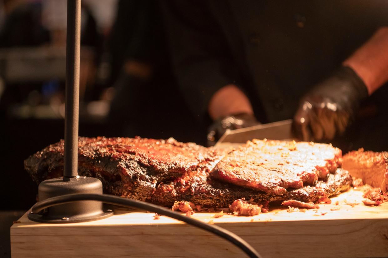 Mike Jackson of One Nation slices beef brisket for dishes during Que the Creek BBQ Festival at Kellogg Arena in Battle Creek on Saturday, Feb. 4, 2023.