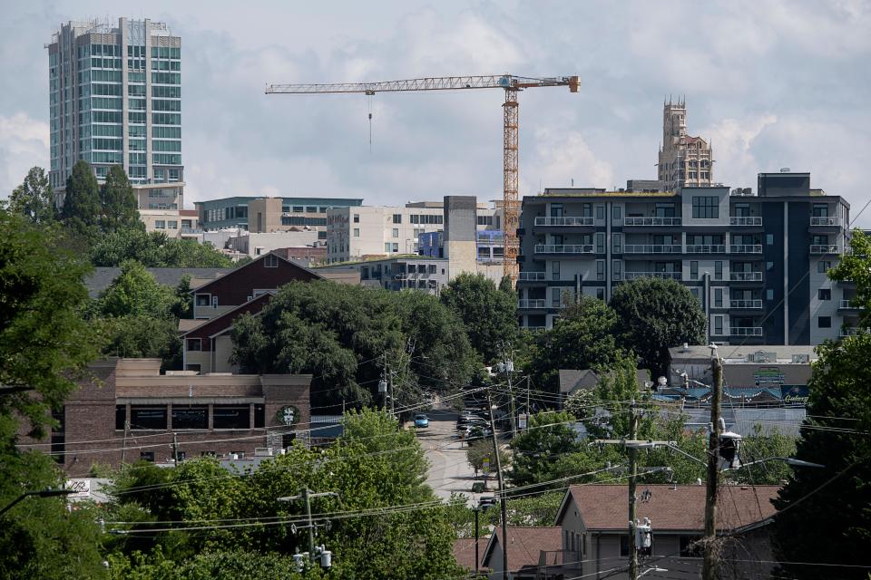 A construction crane in the Asheville skyline is seen from the South Slope July 6, 2023.