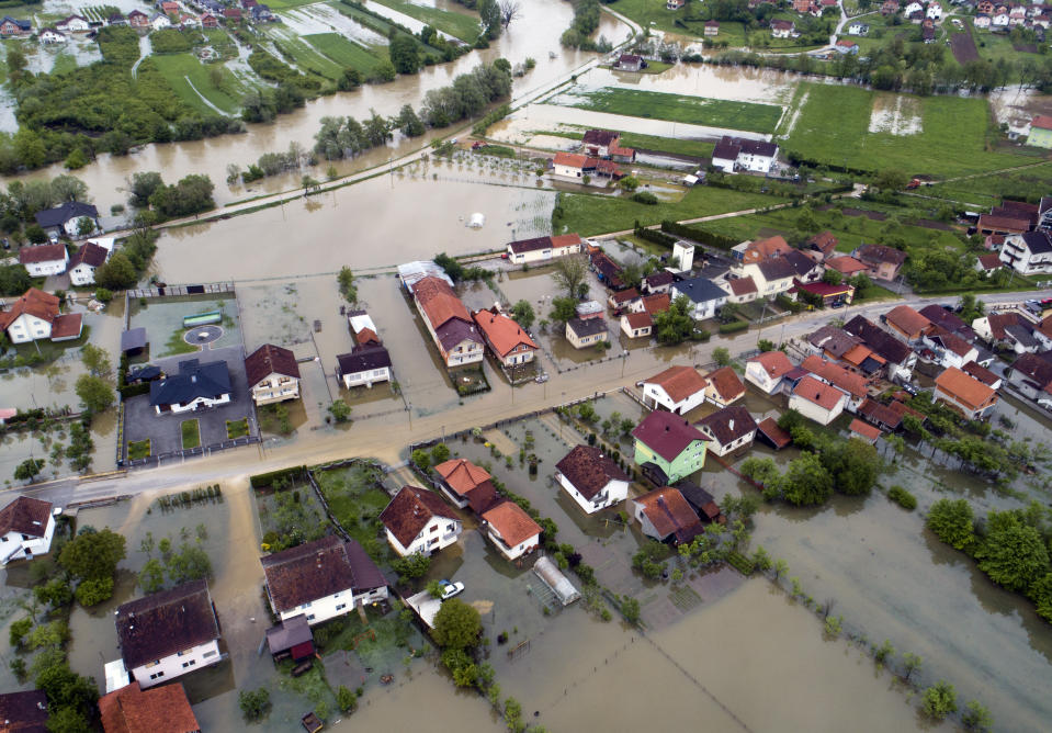 This aerial photo shows flooded neighborhood in Sanski Most, Bosnia-Herzegovina, Tuesday, May 14, 2019. Homes and roads have been flooded in parts of Bosnia after rivers broke their banks following heavy rains, triggering concerns Tuesday of a repeat of floods five years ago when dozens died. (AP Photo/Darko Bandic)