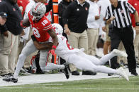 Ohio State receiver Marvin Harrison, left, is forced out of bounds by Rutgers defensive back Christian Braswell during the first half of an NCAA college football game, Saturday, Oct. 1, 2022, in Columbus, Ohio. (AP Photo/Jay LaPrete)