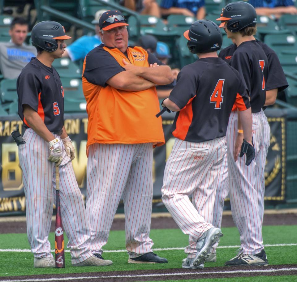 Washington head coach Kyle Wisher talks to some of his players during a break in the action against Crystal Lake South in the Class 3A state baseball third-place game Saturday, June 11, 2022 at Duly Health & Care Field in Joliet.