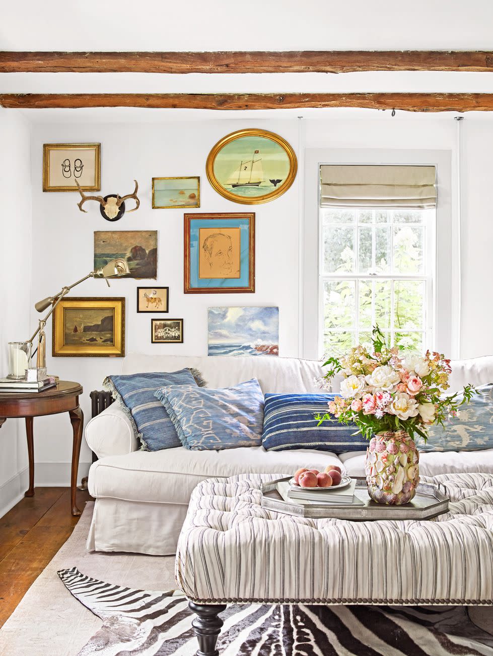 living room with white walls and a gallery wall and comfy furniture