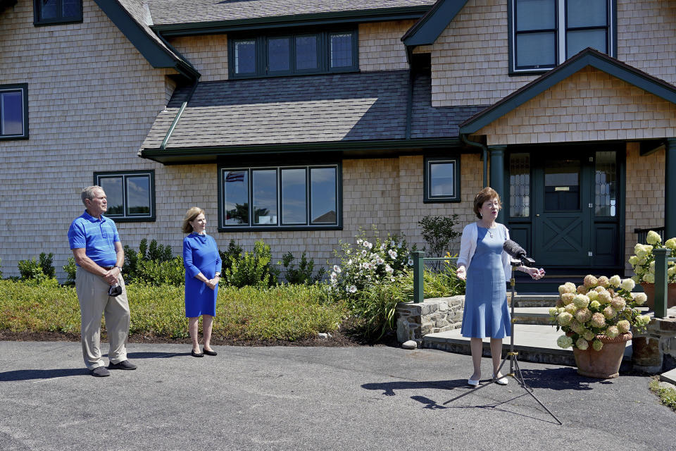 Sen. Susan Collins, R-Maine, right, speaks at a microphone after having lunch with former President George W. Bush and his wife Laura Bush, Friday, Aug. 21, 2020, in Kennebunkport, Maine. (AP Photo/Mary Schwalm)