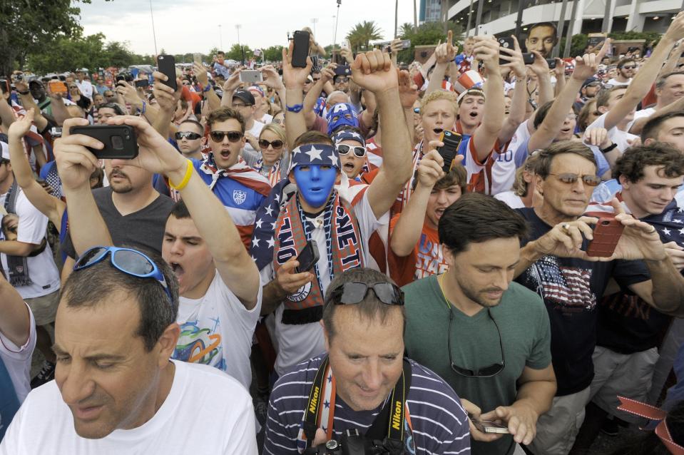 Soccer fans cheer on the United States men's team as they arrive for a 2014 game against Nigeria.