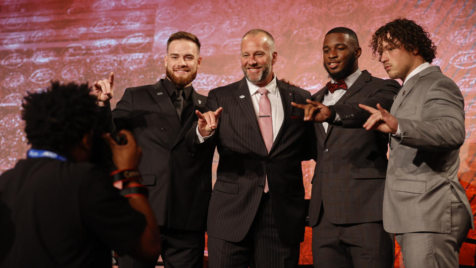 From left, North Carolina State's Devin Leary, coach Dave Doeren, Isaiah Moore and Drake Thomas pose for a photo onstage at the NCAA college football Atlantic Coast Conference Media Days in Charlotte, N.C., Wednesday, July 20, 2022. (AP Photo/Nell Redmond)