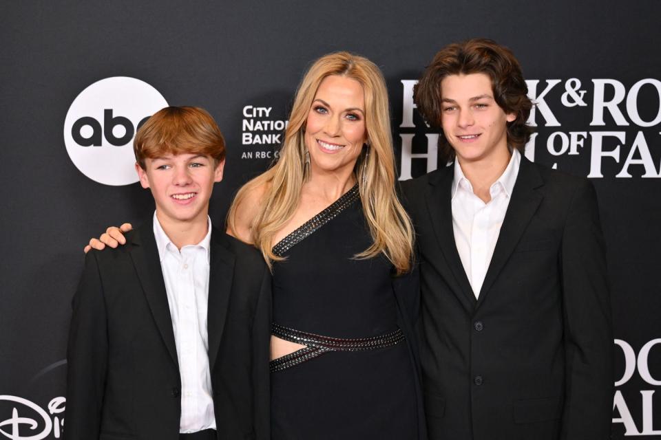 <p>ANGELA WEISS/AFP via Getty </p> Sheryl Crow and sons Levi (left) and Wyatt (right) attend the 38th Annual Rock & Roll Hall of Fame induction ceremony.