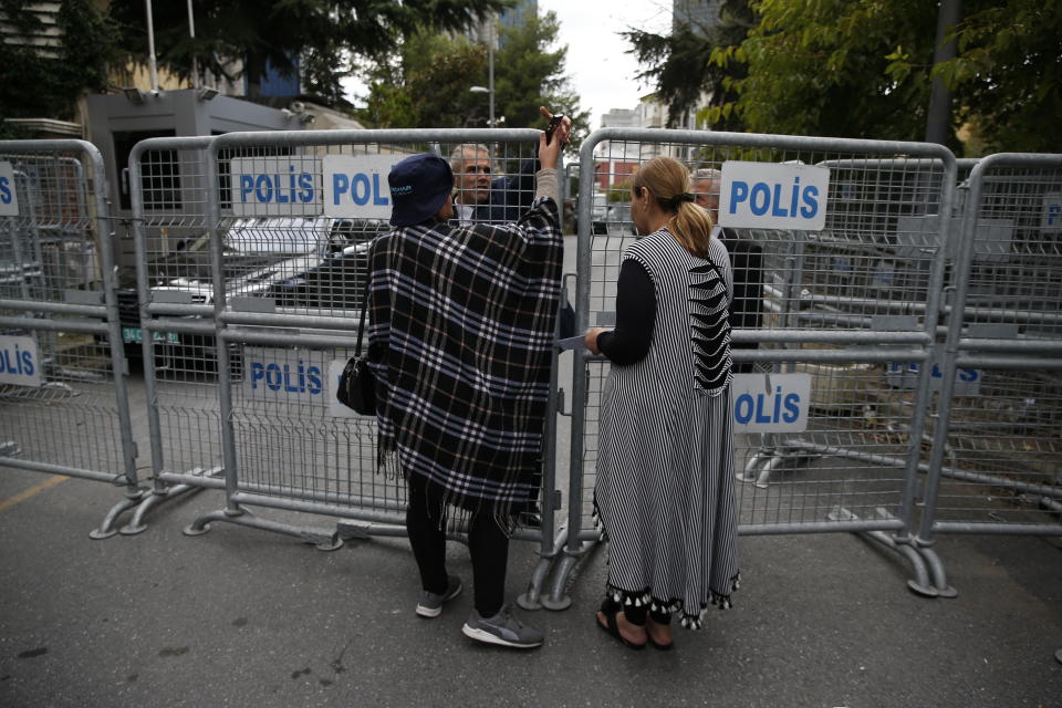 Civilians wait to enter a blocked road leading to the Saudi Arabia consulate in Istanbul, Tuesday, Oct. 9, 2018. Saudi journalist Jamal Khashoggi disappeared a week ago after entering Saudi Arabia's consulate to obtain paperwork required for his marriage to his Turkish fiancee. Turkish officials have alleged he was killed in the compound while Saudis officials said he left the building unharmed. (AP Photo/Lefteris Pitarakis)