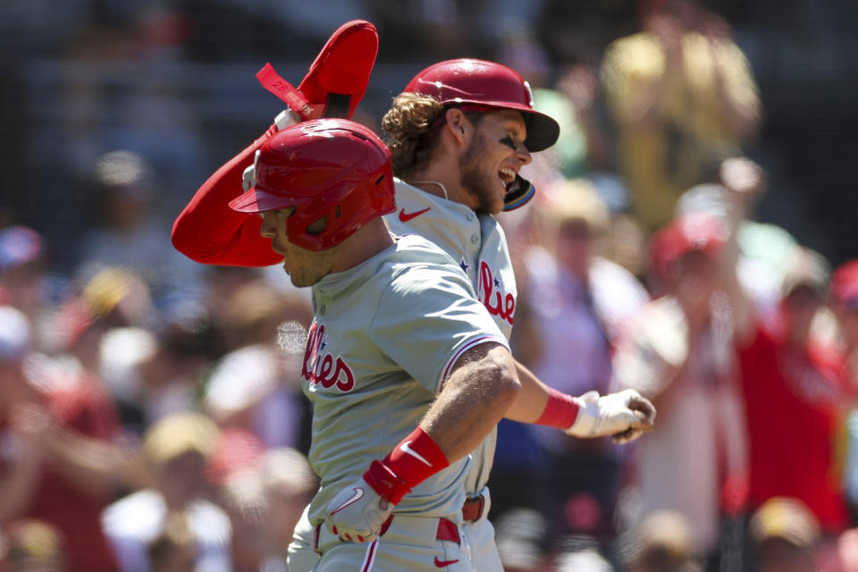 Philadelphia Phillies' J.T. Realmuto, left, celebrates with Alec Bohm after his two-run home run during the sixth inning of a baseball game against the San Diego Padres, Sunday, April 28, 2024, in San Diego. (AP Photo/Brandon Sloter)