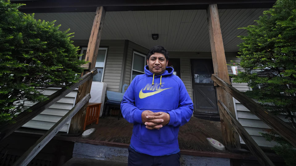 Lucio Perez poses at the front steps of his home, where he has lived with his family since March, Thursday, July 8, 2021, in Springfield, Mass. Just a few months ago, Perez moved out of a western Massachusetts church he'd lived in for more than three years to avoid deportation. Immigration authorities in March granted the 37-year-old Guatemalan national a temporary stay in his deportation while he argued to have his immigration case reconsidered. (AP Photo/Charles Krupa)