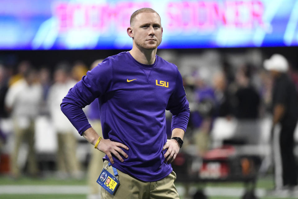 LSU offensive coach Joe Brady watches his team warm up before the Peach Bowl between LSU and Oklahoma. (AP)