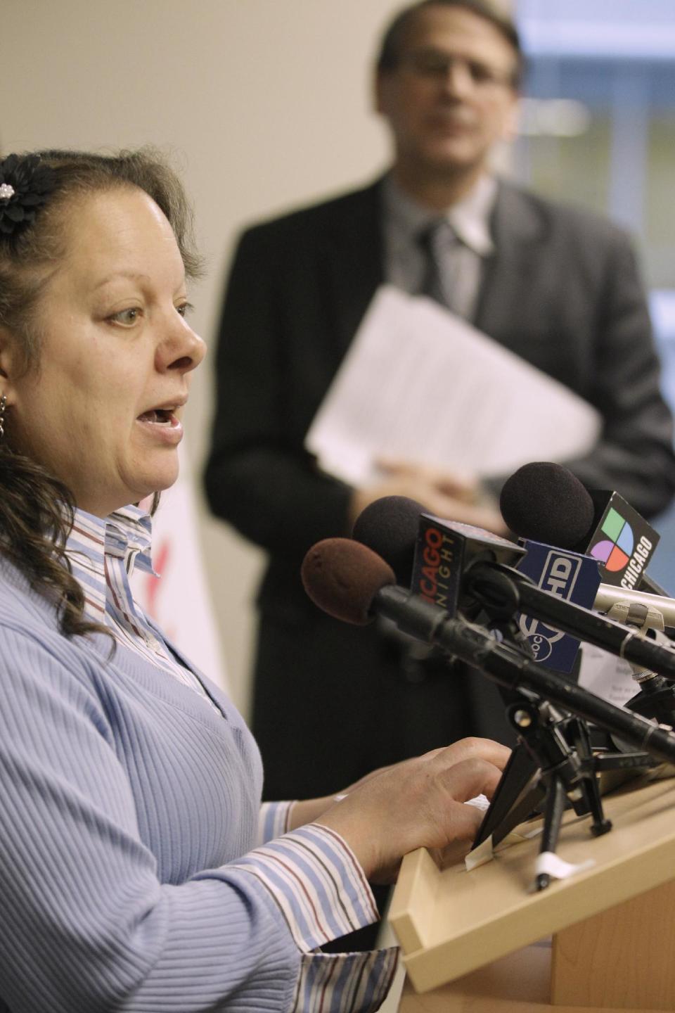 Ramona Ortiz-Patino, one of two former patients of Swedish Covenant Hospital who are now plaintiffs in a lawsuit against the health care facility speaks at a news conference accompanied by attoreny Alan Alop, right, of the legal services group LAF, Thursday, Nov. 29, 2012 in Chicago. The lawsuit claims that the nonprofit hospital failed to provide charity care to low-income uninsured patients which is required by law in exchange for state tax break benefits. (AP Photo/M. Spencer Green)