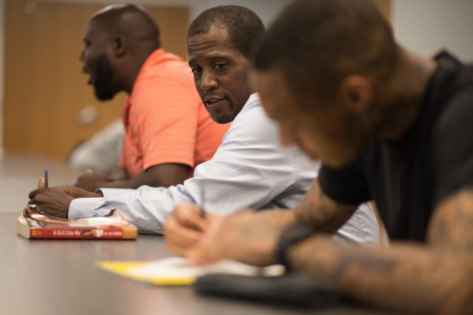 A participant takes notes during a 'Save Our Sons' course.