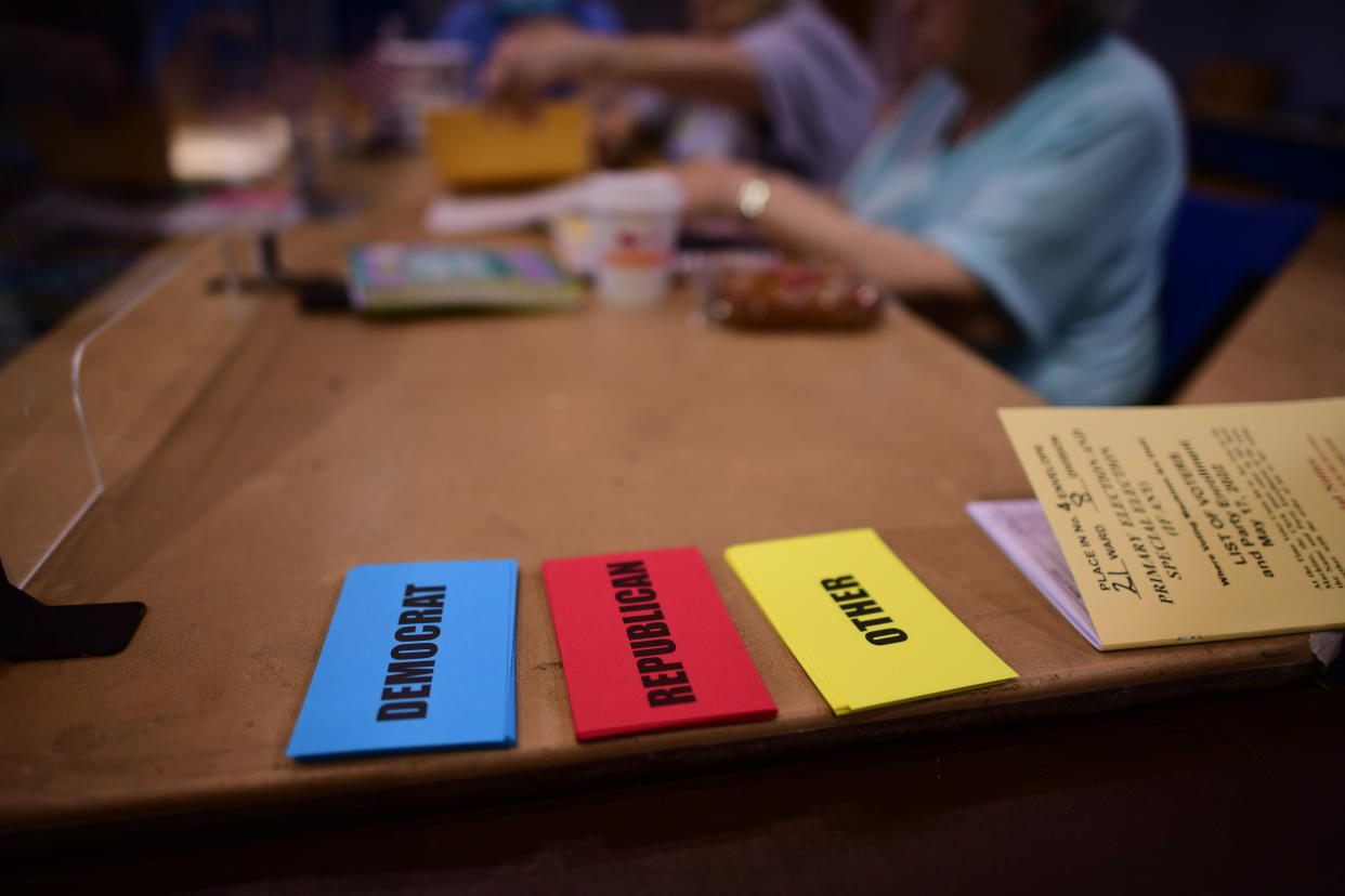 Three cards reading Democrat, Republican and Other on a table.