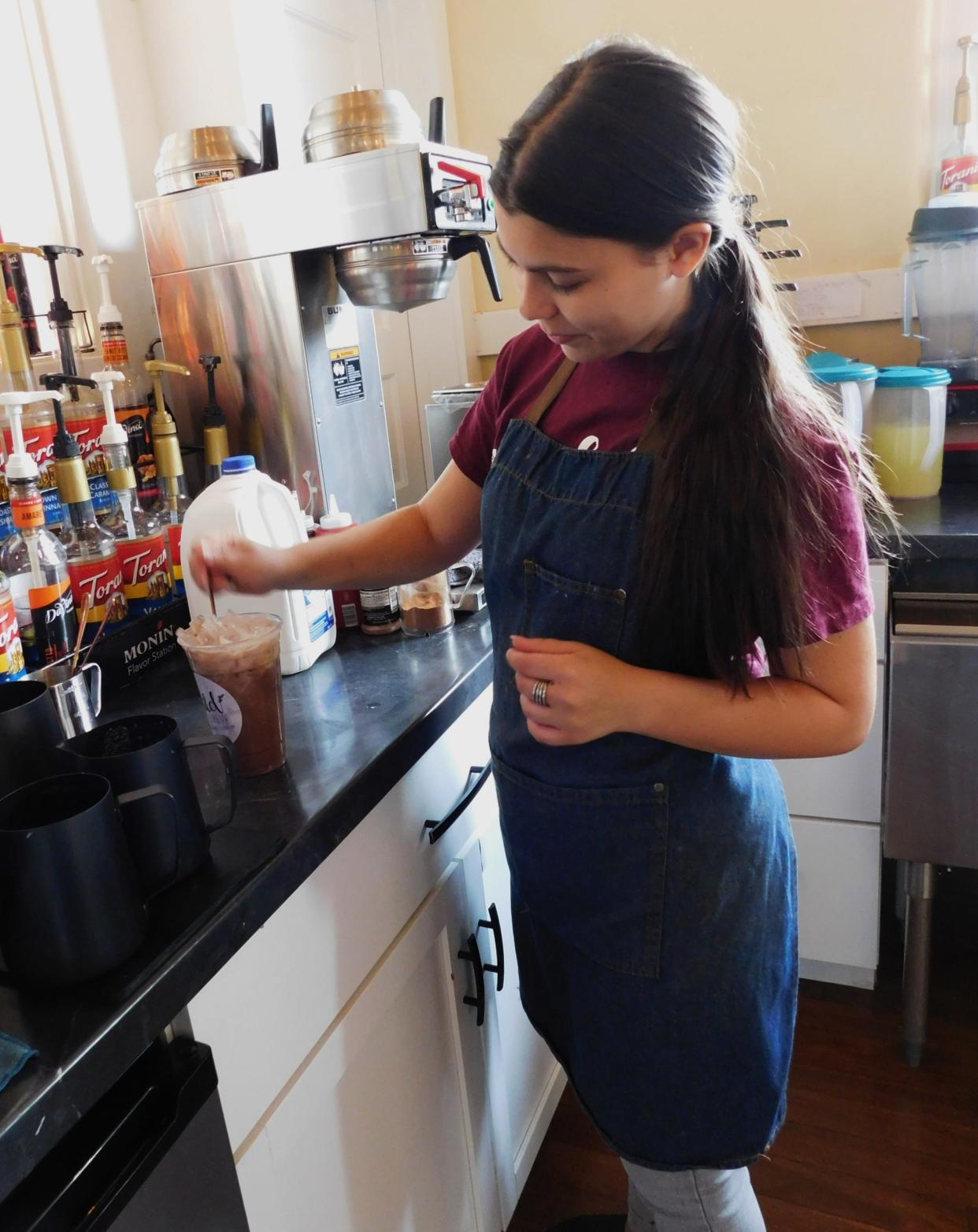 Rose Mira mixes a hot beverage at the Clyde Wild Brew shop.