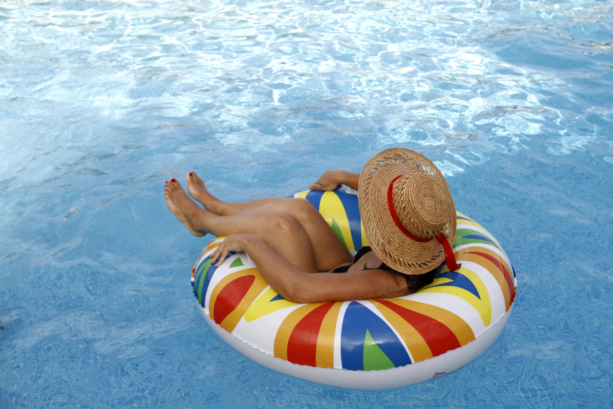 Woman resting on inflatable ring at pool